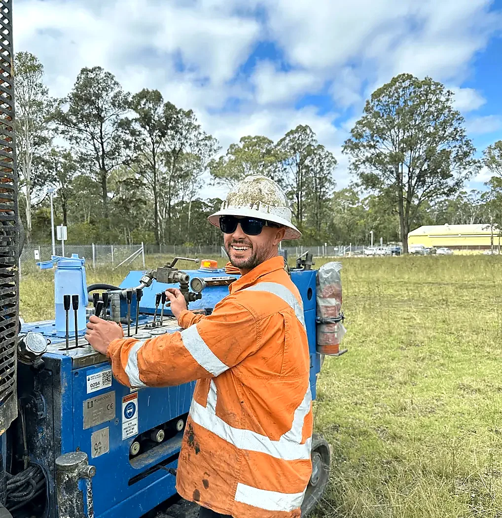 Geotrace field operator at the controls of a blue drilling rig